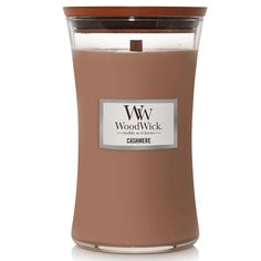 the woodwick candle is brown and has a white label on it's front