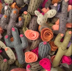 a bunch of cactus plants with flowers on them and some are made out of felt