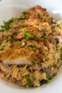 a white plate topped with pasta and meat