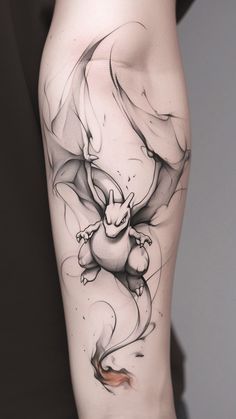 a woman's leg with a tattoo on it and a dragon flying through the air