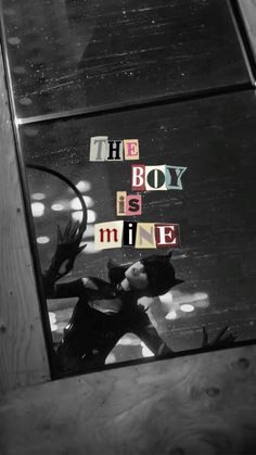 the boy is mine written in cut out letters on a wooden surface with a black and white background