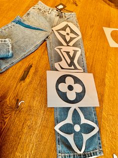 some cut out pieces of clothing sitting on top of a wooden table