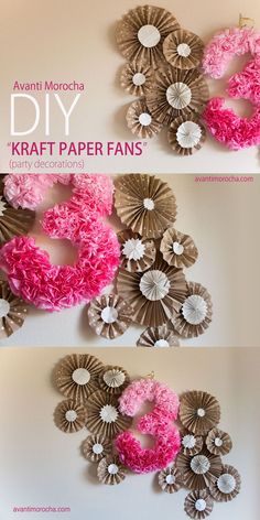 a coffee filter number hanging on the wall with pink flowers and paper fans around it