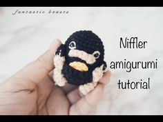 a crocheted stuffed animal is being held in someone's hand with the caption niffler amgurmi tutor