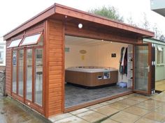 a wooden building with a hot tub inside of it