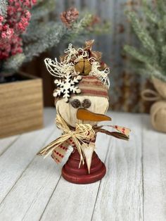 a snowman figurine sitting on top of a wooden table