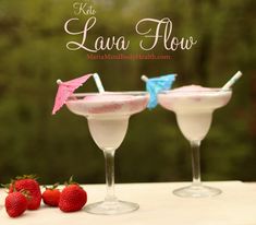 two martinis with strawberries sit on a table next to the words lava flow