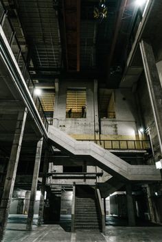 an empty parking garage with stairs leading up to the second floor