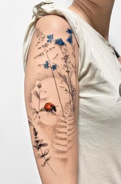 a ladybug tattoo on the left arm