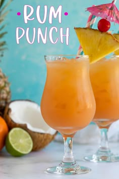 two glasses filled with rum punch and garnished with pineapple