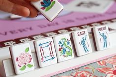 a person is playing with some type of magnets on a board game set that includes letters and numbers