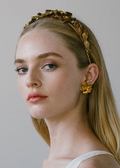 Each Rowena Headband is constructed by hand in our Brooklyn sudio, so each one is one-of-a-kind and no two are entirely alike. Featuring a combination of golden blooms and life-like foliage, the Rowena evokes an ethereal, Grecian mood, and can be worn atop the head like a headband, or in the back of the head, framing an up-do or loose waves. For the perfect wearing, wear this headband with the coordinating Rowena Earrings. Dimensions: 6.75 x 6 inches, 1.5 inches height Weight: 97g Floral Headband Wedding Guest, Bridal Styling, Luxury Hair Accessories, Jennifer Behr, Floral Studs, Gold Headband, Gold Rings Fashion, Luxury Hair, Antique Earrings