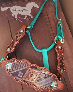 a horse bridle with a turquoise ribbon around it