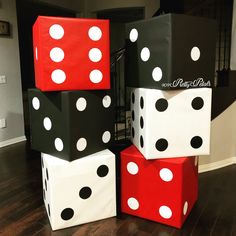 four dice boxes stacked on top of each other in the middle of a living room