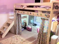 a child's bedroom with a loft bed and stairs