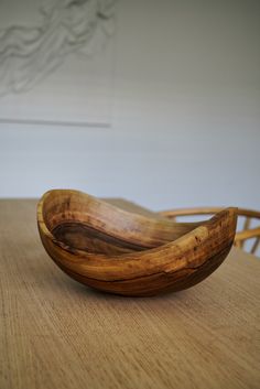 a wooden bowl sitting on top of a table