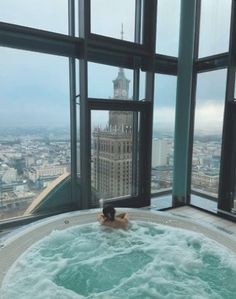 a person in a large bath tub overlooking the city