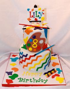 a birthday cake with an artistic theme on it