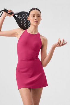 It’s a fresh ’90s spin on your favorite tennis dress, complete with a high neck, a fitted waist, and a short, swingy hem. But that’s not even the best part—see the open back and the chic trio of straps? Practical details include a built-in shelf bra with removable cups and built-in shorts with pockets for holding a tennis ball or two. Add some sneakers and get ready to serve. Alo Tennis Dress, Alo Dress, Active Dresses, Sport Fits, Womens Onesie, Sports Outfits, Pink Activewear, Gray Accessories, Vintage Tennis