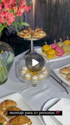 a table topped with plates and trays filled with pastries on top of it