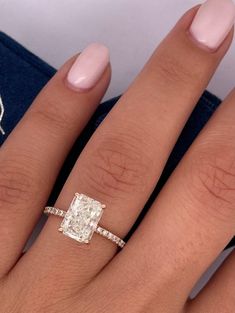 a woman's hand with a diamond ring on it