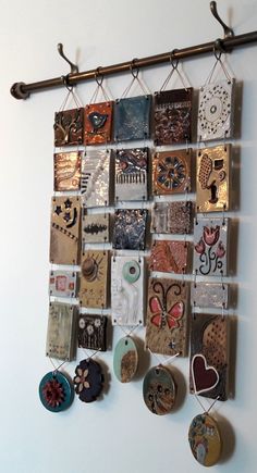 there are many different magnets hanging on the wall with metal bars attached to it