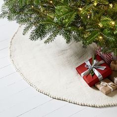 a small christmas tree with presents under it