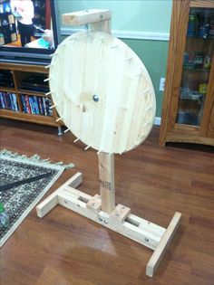 a large wooden object sitting on top of a hard wood floor next to a rug