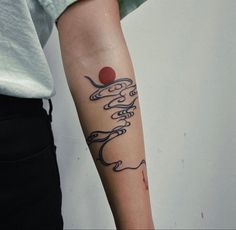 a woman's arm with a tattoo on it that has writing and a red ball