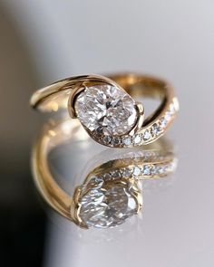 a close up of a diamond ring on a table