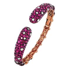 The Ruby cuff bangle has an immaculate look, crafted with 12.81 carats ruby and 1.45-carat round-rose cut diamonds on 18 karat rose gold by Nigaam. The cuff bangle is studded with prong set round rubies and diamonds. The diamonds are of G-H color grade and SI1 clarity. Please follow the Luxury Jewels storefront to view the latest collections & exclusive one of a kind pieces. Luxury Jewels is proudly rated as a Top Seller on 1stDibs with all 5 star customer reviews. JEWELRY SPECIFICATION: Approx. Luxury Ruby Bracelets, Pink Gold Bracelet, Rose Gold Bangle Bracelet, Modern Bangle, 18k Gold Bangle, Rubies And Diamonds, Diamond Cuff Bracelet, Crystal Belt, Rose Gold Bangle