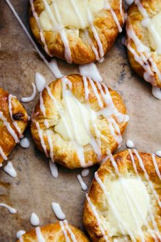 there are many croissants with white icing on them