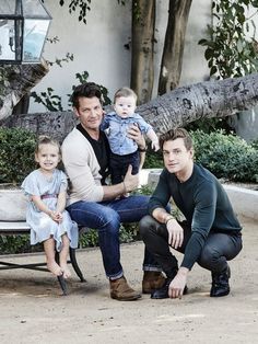 a man and two children sitting on a bench