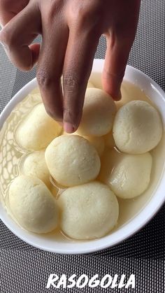 a person reaching for some food in a bowl