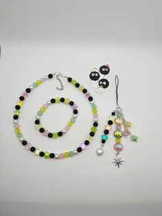 a necklace, bracelet and earring set on a white surface with an animal sticker