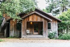 a small wooden cabin with stairs leading up to it