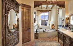 a bathroom with a large tub and double sinks