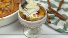 there is a bowl of food with ice cream on top and cinnamon sticks in the background