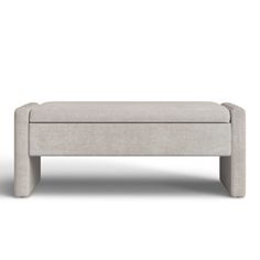 an upholstered footstool in light grey fabric