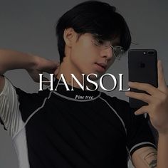 a young man is holding his cell phone and looking at it with the word hansol in front of him