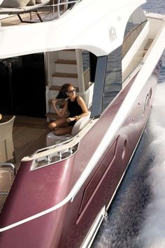 a woman sitting on the back of a boat