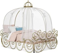 a white bed with a gold metal frame and canopy