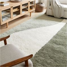 a living room with a chair and rug on the floor