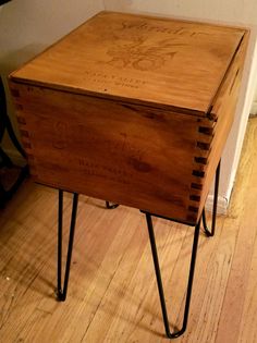 an old wooden box with hairpin legs on the floor