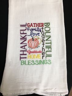 a white kitchen towel with the words thanksgiving written on it