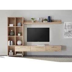 an entertainment center with shelves and a flat screen tv mounted on it's wall