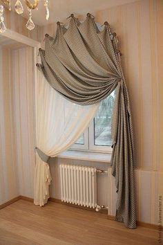 an empty room with a window, curtains and a radiator in the corner