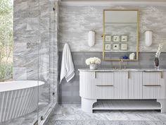 a bathroom with marble and gold accents