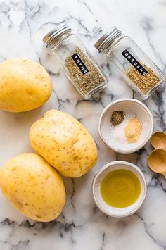 potatoes, spices and seasonings on a marble counter top