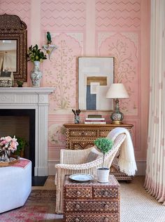 a living room with pink walls and furniture